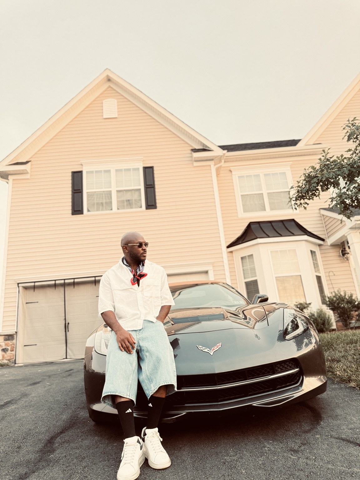 SauciBossy beside a sports car